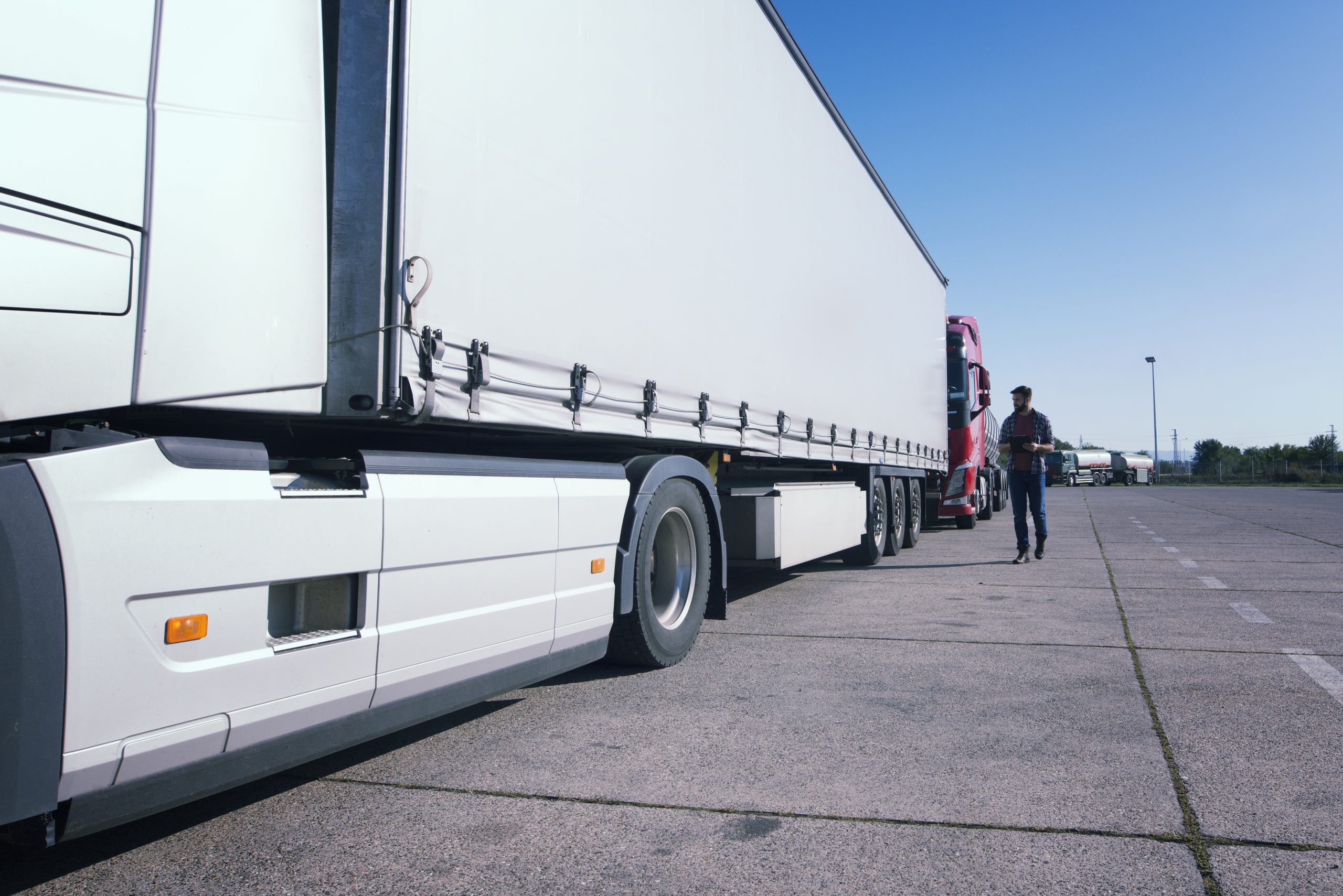 Truck driver inspecting truck long vehicle before driving. HGV Training Courses TrainHGV Train Recruitment lorry instructor