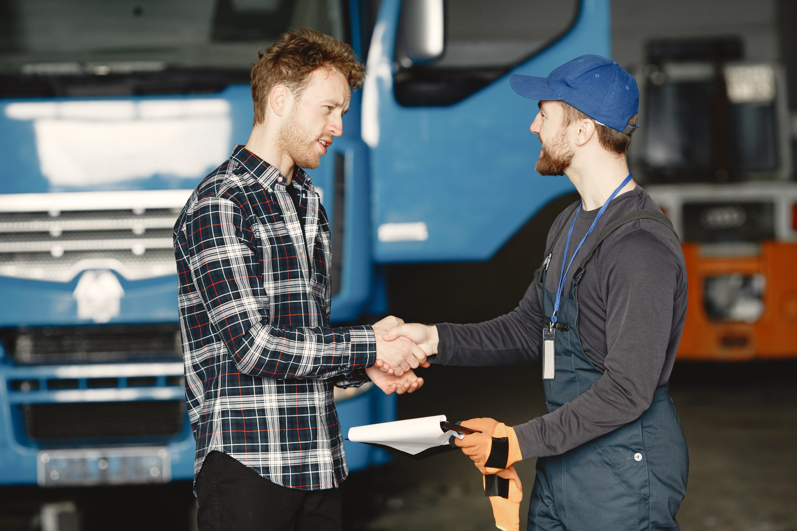 HGV Training Courses TrainHGV Train Recruitment lorry two drivers shaking hands instructor training & recruitment Licenses In Coventry Bedworth or Rugby